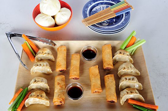 Serving tray with asian appetizers, steamed buns & dipping sauces 