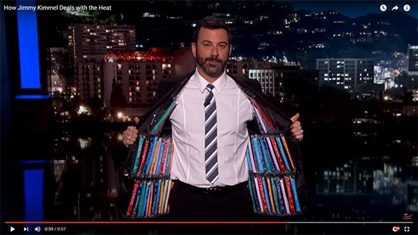 Jimmy Kimmel holds his suit jacket open to show that it's lined with Otter Pops